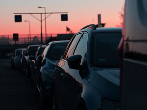 Preview wallpaper cars, sunset, traffic, sky