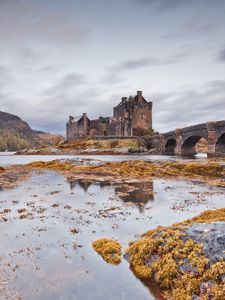 Preview wallpaper castle, bridge, arches, stone, water, lake, stones, vegetation, cold, emptiness, loneliness, terribly