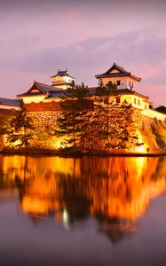 Preview wallpaper castle, building, glow, water, reflection, twilight