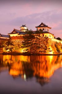 Preview wallpaper castle, building, glow, water, reflection, twilight