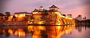 Preview wallpaper castle, building, glow, water, reflection, twilight