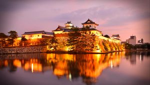 Preview wallpaper castle, building, glow, water, reflection, twilight