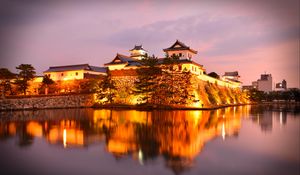 Preview wallpaper castle, building, glow, water, reflection, twilight