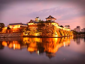 Preview wallpaper castle, building, glow, water, reflection, twilight