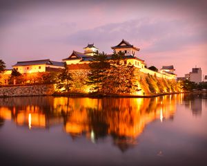 Preview wallpaper castle, building, glow, water, reflection, twilight