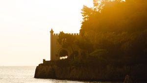 Preview wallpaper castle, coast, cliffs, sea, sunset