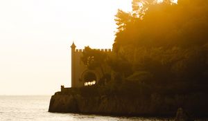 Preview wallpaper castle, coast, cliffs, sea, sunset