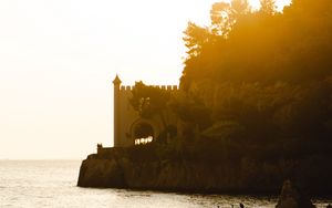 Preview wallpaper castle, coast, cliffs, sea, sunset