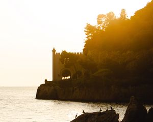 Preview wallpaper castle, coast, cliffs, sea, sunset