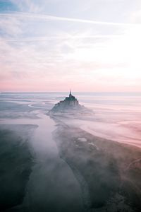 Preview wallpaper castle, island, hill, fog, aerial view