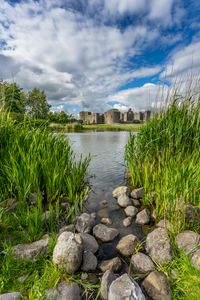 Preview wallpaper castle, lake, stones, grass