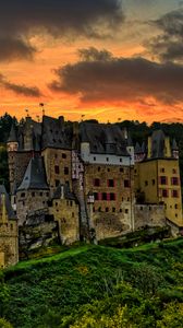 Preview wallpaper castle, mountain, trees, forest, hill, clouds, sunset, dark