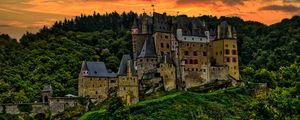 Preview wallpaper castle, mountain, trees, forest, hill, clouds, sunset, dark