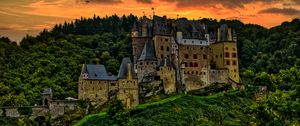 Preview wallpaper castle, mountain, trees, forest, hill, clouds, sunset, dark