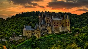 Preview wallpaper castle, mountain, trees, forest, hill, clouds, sunset, dark