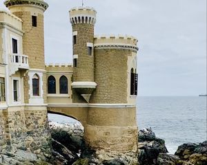 Preview wallpaper castle, towers, architecture, stones, sea, water