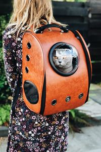 Preview wallpaper cat, backpack, girl, pet, friend, walk