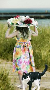 Preview wallpaper cat, child, hat, field, grass