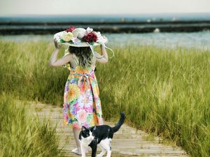 Preview wallpaper cat, child, hat, field, grass