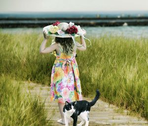 Preview wallpaper cat, child, hat, field, grass