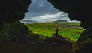 Preview wallpaper cave, man, landscape, coast, greenery
