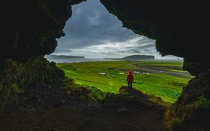 Preview wallpaper cave, man, landscape, coast, greenery