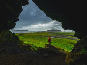 Preview wallpaper cave, man, landscape, coast, greenery