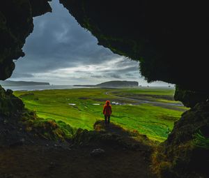 Preview wallpaper cave, man, landscape, coast, greenery