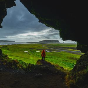 Preview wallpaper cave, man, landscape, coast, greenery