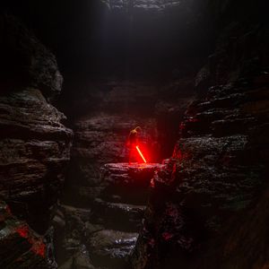 Preview wallpaper cave, man, lightsaber, light