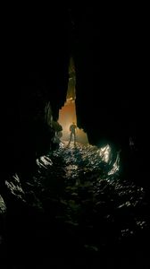 Preview wallpaper cave, man, silhouette, loneliness, river