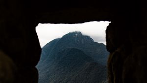 Preview wallpaper cave, mountain, forest, peak, mountain range