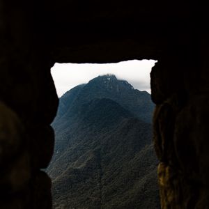 Preview wallpaper cave, mountain, forest, peak, mountain range