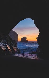 Preview wallpaper cave, rocks, sea, sunset