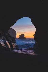 Preview wallpaper cave, rocks, sea, sunset