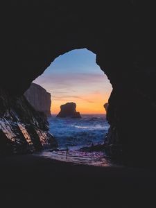 Preview wallpaper cave, rocks, sea, sunset