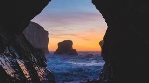 Preview wallpaper cave, rocks, sea, sunset