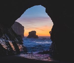 Preview wallpaper cave, rocks, sea, sunset