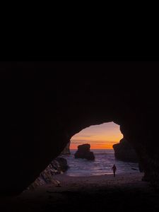 Preview wallpaper cave, rocks, silhouette, water, sunset