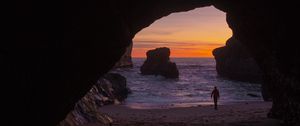 Preview wallpaper cave, rocks, silhouette, water, sunset