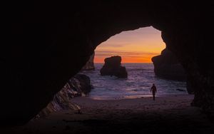 Preview wallpaper cave, rocks, silhouette, water, sunset