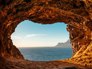 Preview wallpaper cave, rocks, stones, sea, horizon