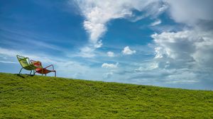 Preview wallpaper chairs, grass, hill, sky, clouds