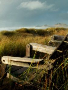 Preview wallpaper chairs, grass, sea, storm, wind