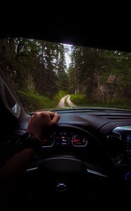 Preview wallpaper chevrolet, car, steering wheel, hand, forest