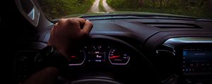 Preview wallpaper chevrolet, car, steering wheel, hand, forest