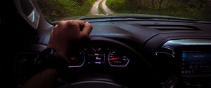 Preview wallpaper chevrolet, car, steering wheel, hand, forest