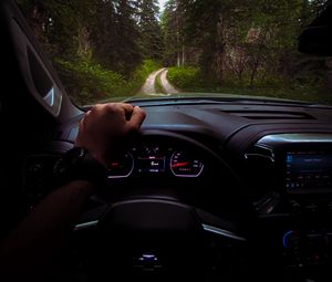 Preview wallpaper chevrolet, car, steering wheel, hand, forest