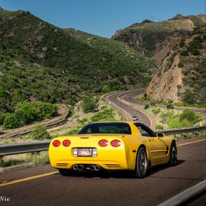 Preview wallpaper chevrolet corvette, chevrolet, car, yellow, back view, road