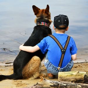 Preview wallpaper child, dog, beach, sand